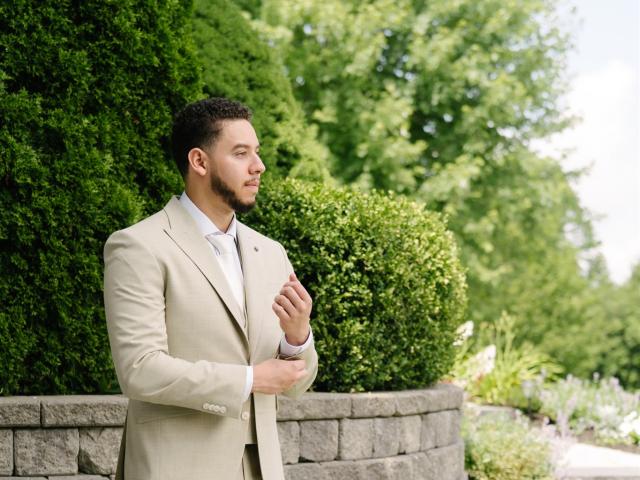 a person standing in front of a brick building