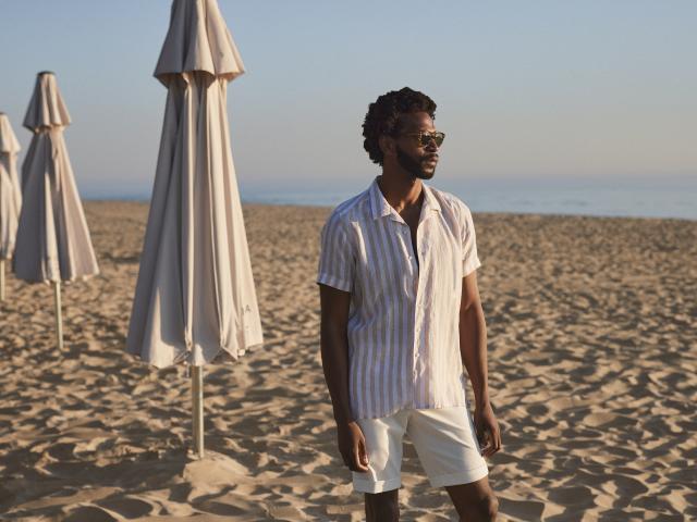 a man standing on top of a sandy beach