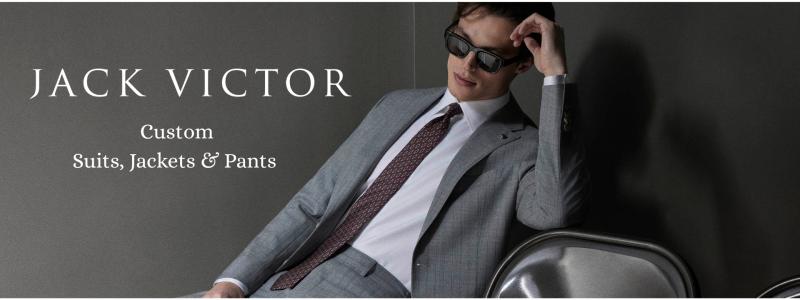 a man wearing a suit and tie talking on a cell phone