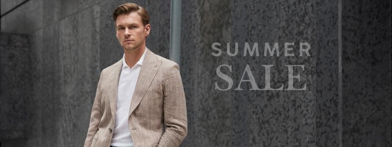 a man in a suit standing in front of a building