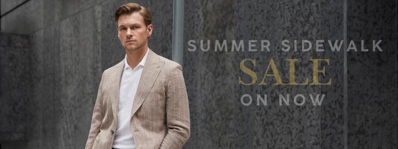 a man in a suit standing in front of a building