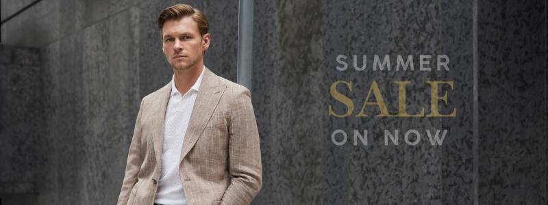 a man in a suit standing in front of a building