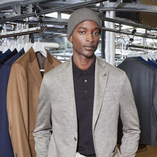 a person posing for the camera at a menswear store