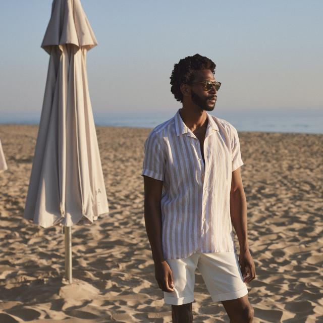 a man standing on top of a sandy beach