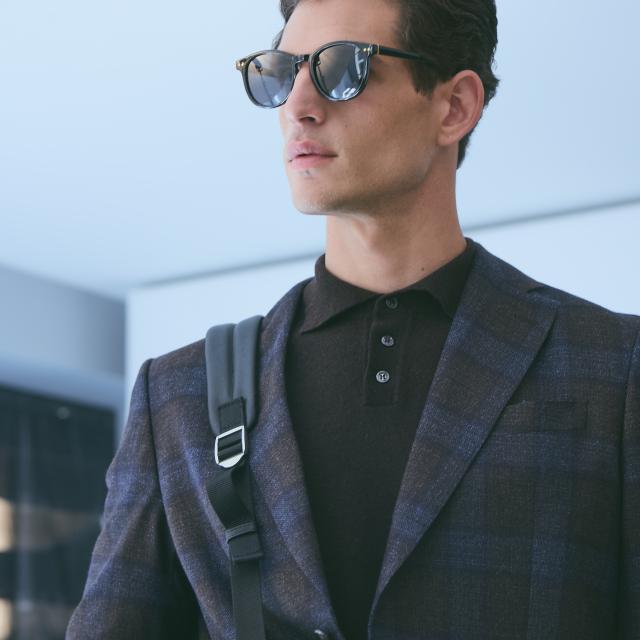 a man wearing sunglasses posing for the camera